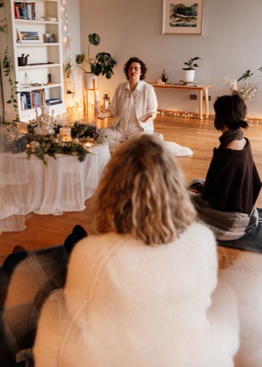 Hridaya holding space at the altar during a session