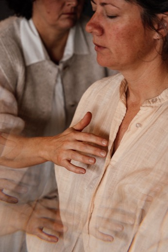 A steadying hand on a participant's chest